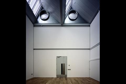 One of the main studio spaces, with ceiling beams 7.5m above the ground. The circular cowls covering the natural ventilation lie above the beam.